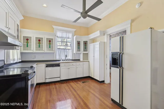 a view of entryway with a front door and wooden floor