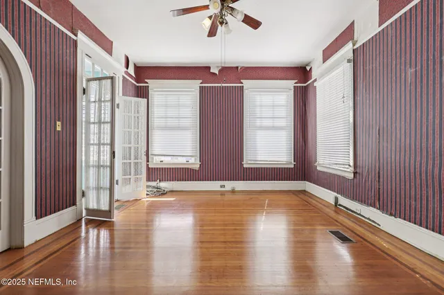 wooden floor in an empty room with a window