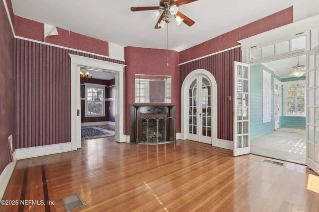 a view of a livingroom with wooden floor and a ceiling fan