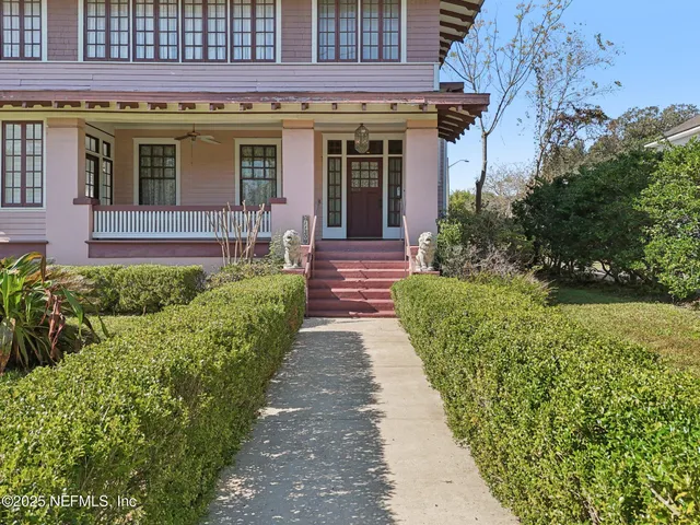 a front view of a house with a garden