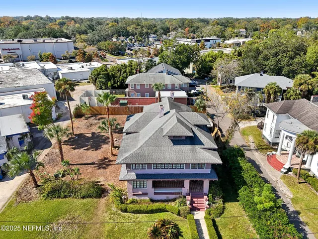 a view of street along with retail shop and buildings