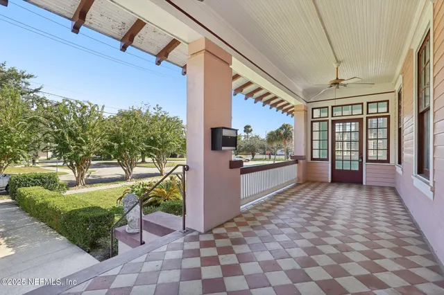 a view of a hallway with wooden floor a fireplace and window