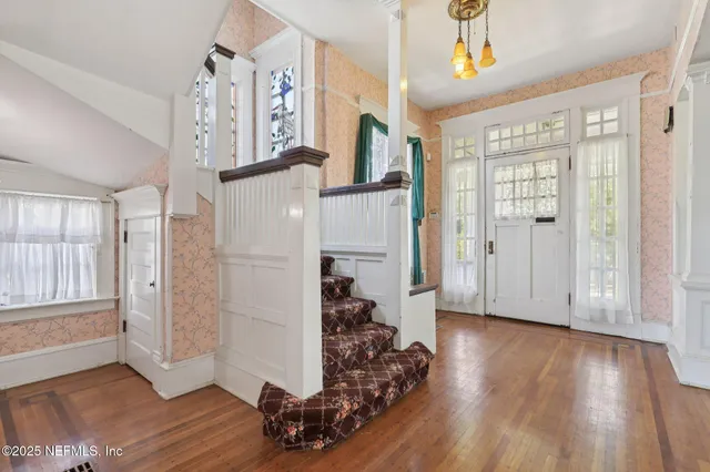 a view of a livingroom with a fireplace and wooden floor