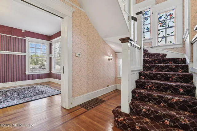 a living room with a rug and a fireplace