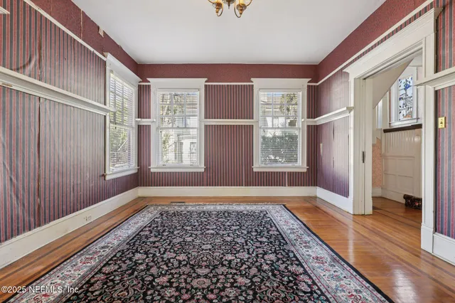 a kitchen with stainless steel appliances granite countertop a stove a sink and white cabinets
