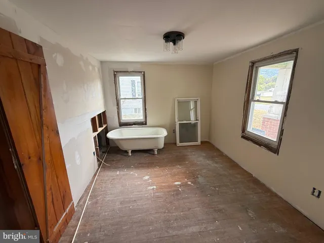 a view of a livingroom with a furniture and an empty room