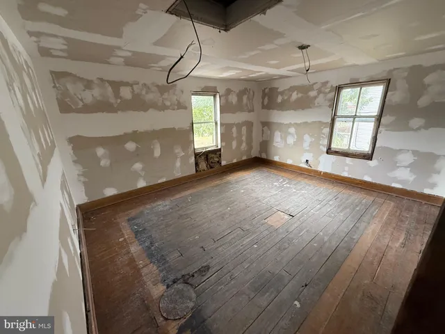 a view of a room with wooden floor