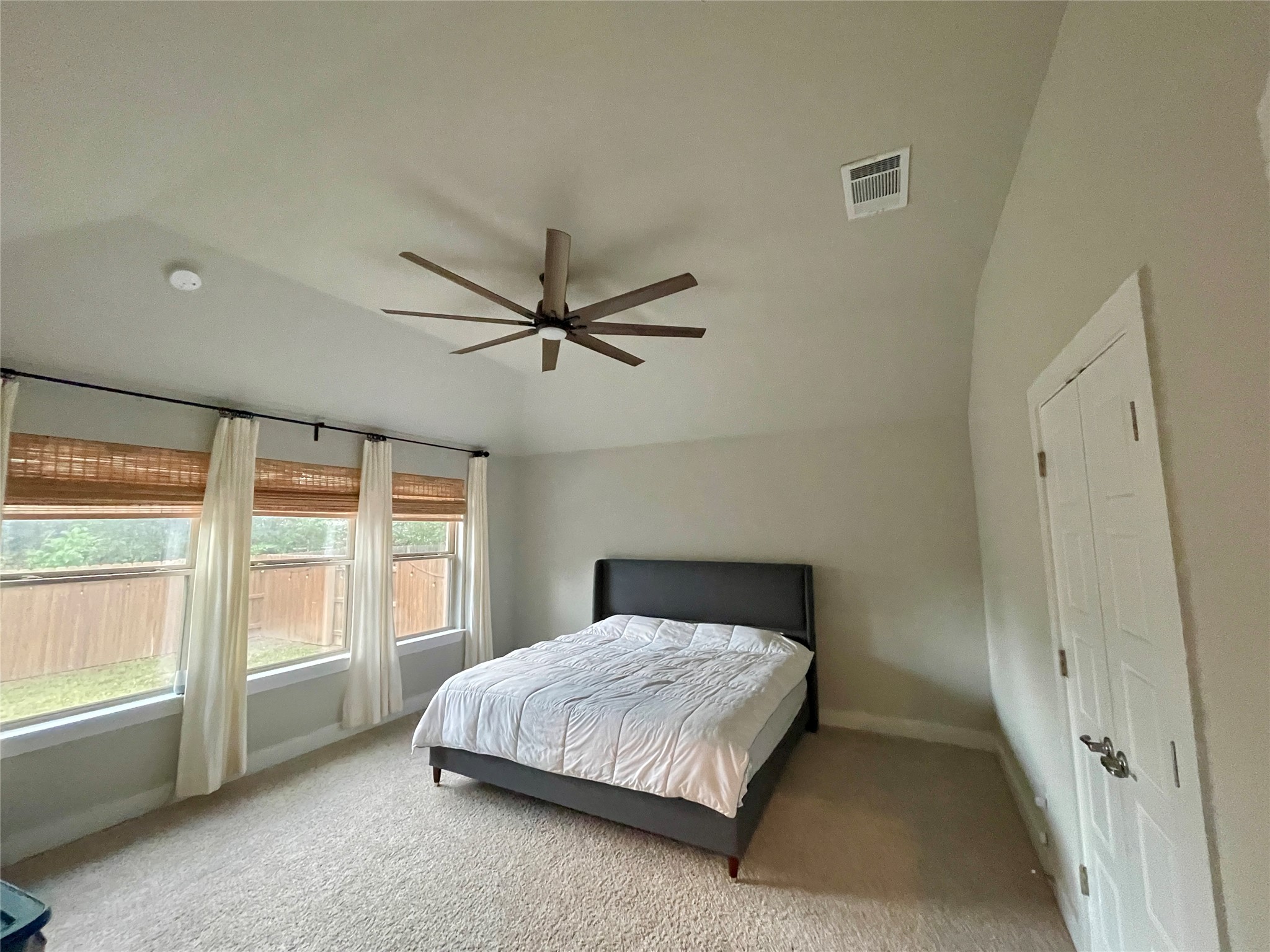 120 Sail Wind Way Georgetown, TX 78633 - Photo 14 of 25 a bedroom with a large bed and a chandelier