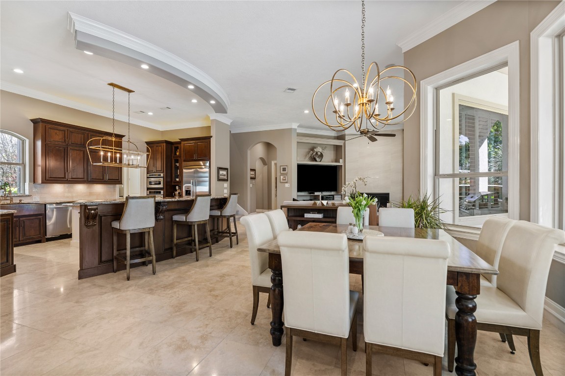 82 Manor Lake Estates Circle Spring, TX 77379 - Photo 14 of 50 From here, the breakfast room flows seamlessly into the kitchen and family room, creating an open layout that supports both casual dining and effortless entertaining. The connection to the outdoors makes the entire space feel airy and welcoming.