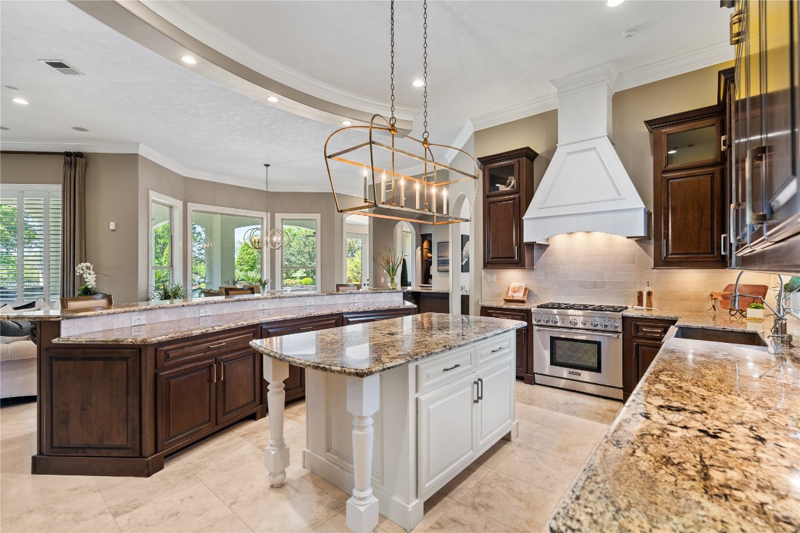 82 Manor Lake Estates Circle Spring, TX 77379 - Photo 18 of 50 From this angle, the kitchen opens gracefully to the breakfast area and family room, creating an effortless flow for hosting. The generous wraparound counter seating and oversized work surfaces make it ideal for gathering while meals are prepared
