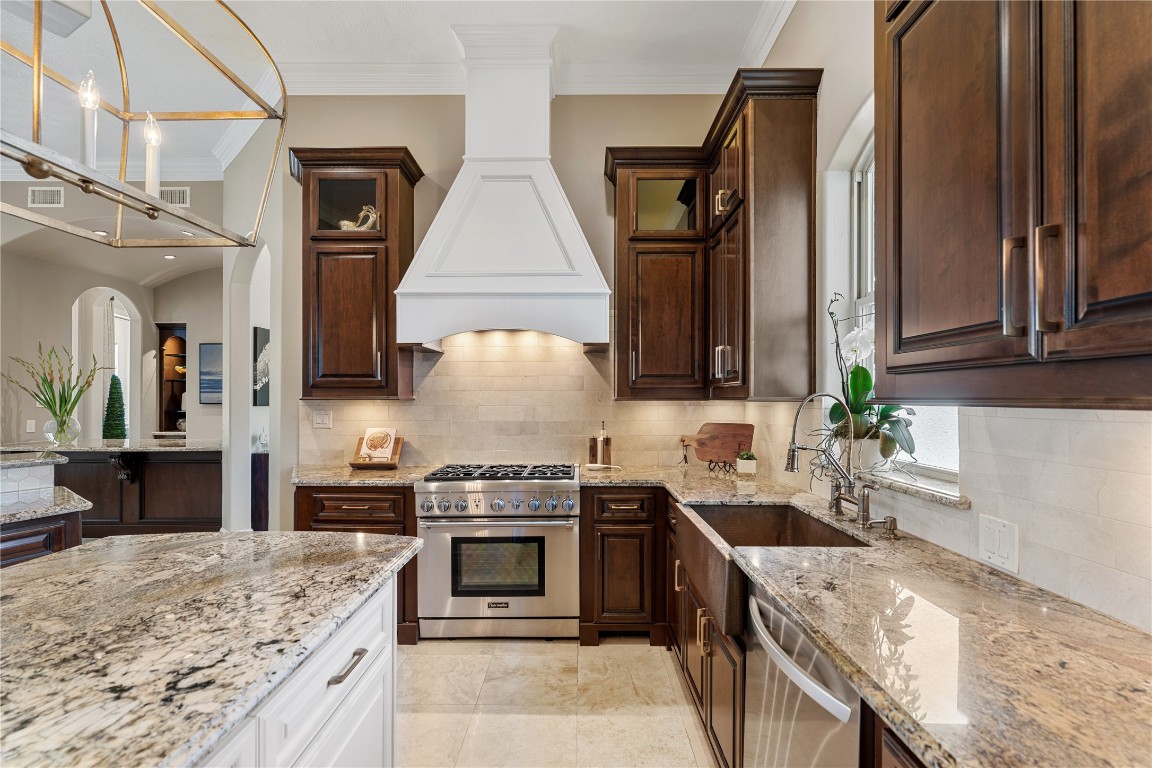 82 Manor Lake Estates Circle Spring, TX 77379 - Photo 19 of 50 a kitchen with stainless steel appliances granite countertop a sink stove and refrigerator