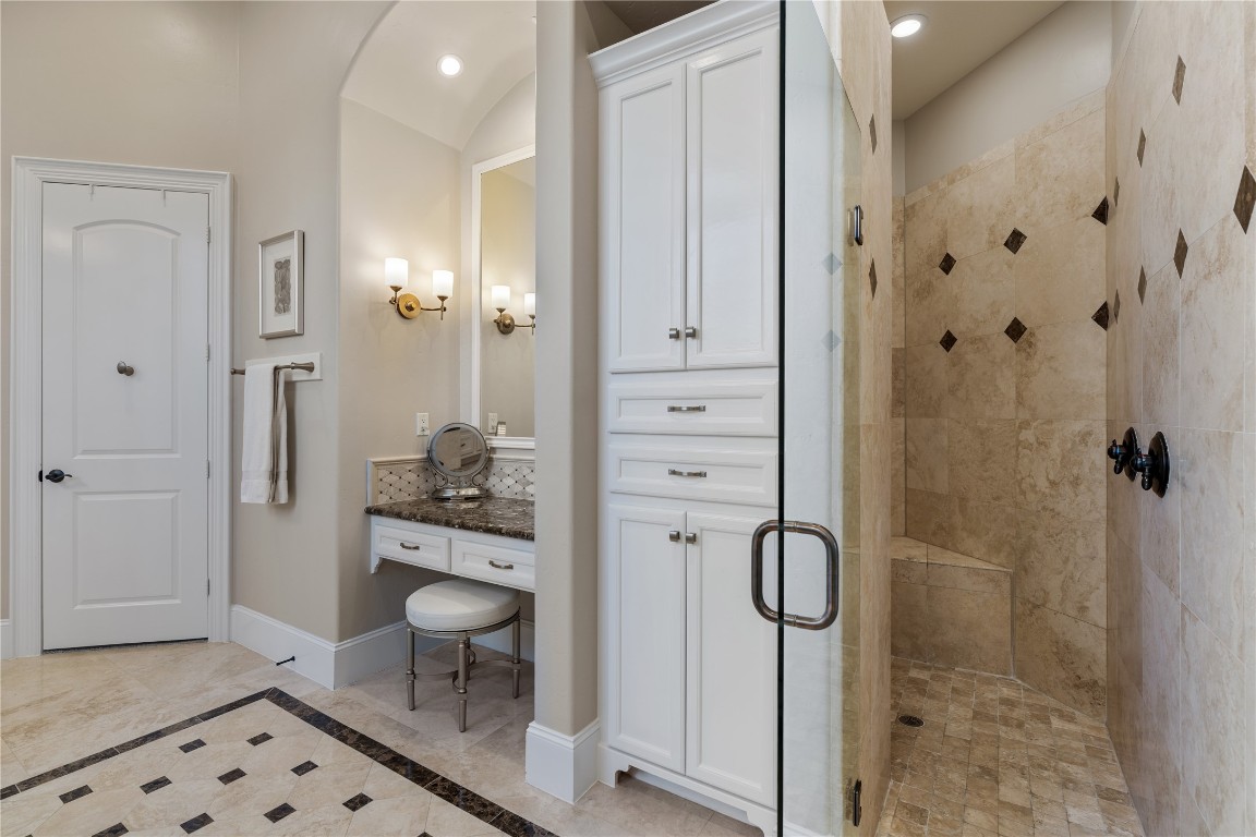 82 Manor Lake Estates Circle Spring, TX 77379 - Photo 27 of 50 The walk in shower continues the bath’s polished look with substantial tile work, built in storage, and a clean, timeless finish palette. Paired with the dedicated vanity area, it creates a well appointed owner’s suite experience.