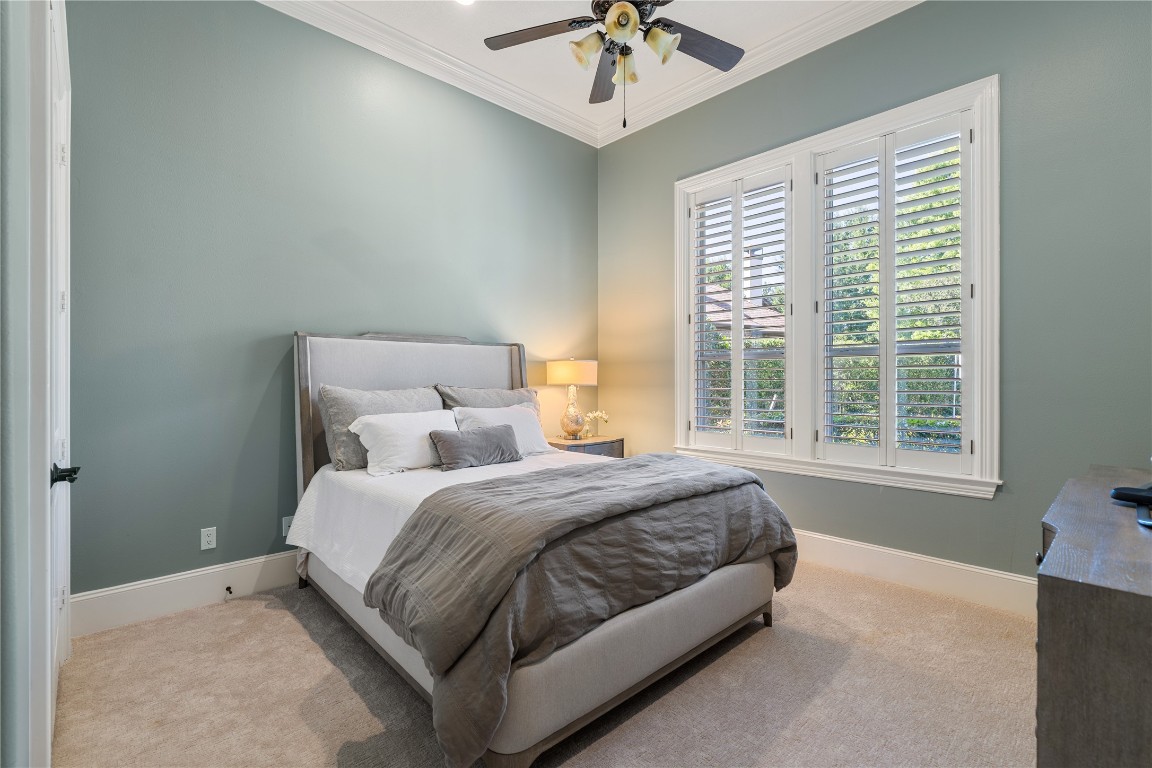 82 Manor Lake Estates Circle Spring, TX 77379 - Photo 29 of 50 a bedroom with a bed and a chandelier