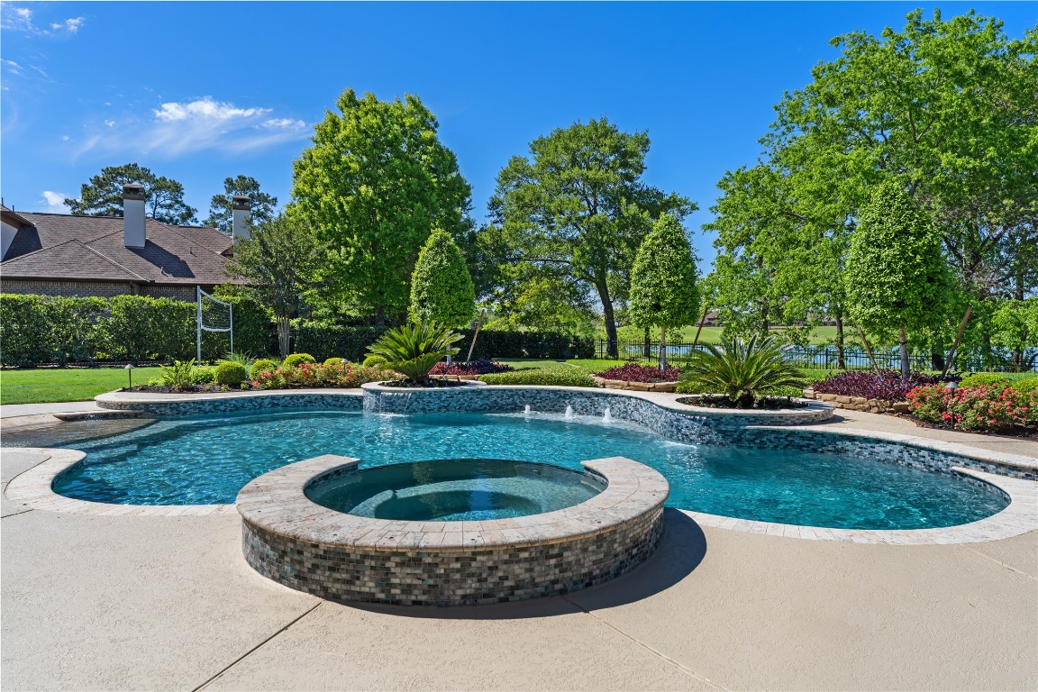 82 Manor Lake Estates Circle Spring, TX 77379 - Photo 43 of 50 a view of a swimming pool with a yard