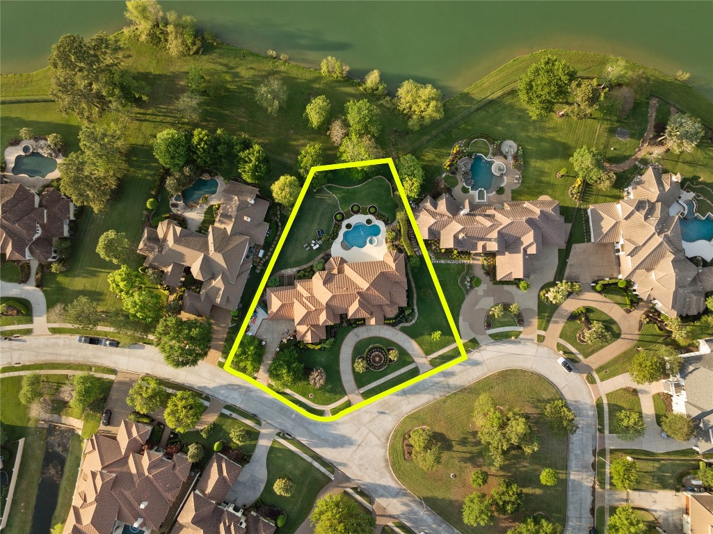 82 Manor Lake Estates Circle Spring, TX 77379 - Photo 46 of 50 An overhead perspective clearly defines the generous homesite, pool layout, and impressive rear yard extending toward the water. The lot shape and depth create a sense of seclusion while still offering a strong visual connection to the surrounding landscape.