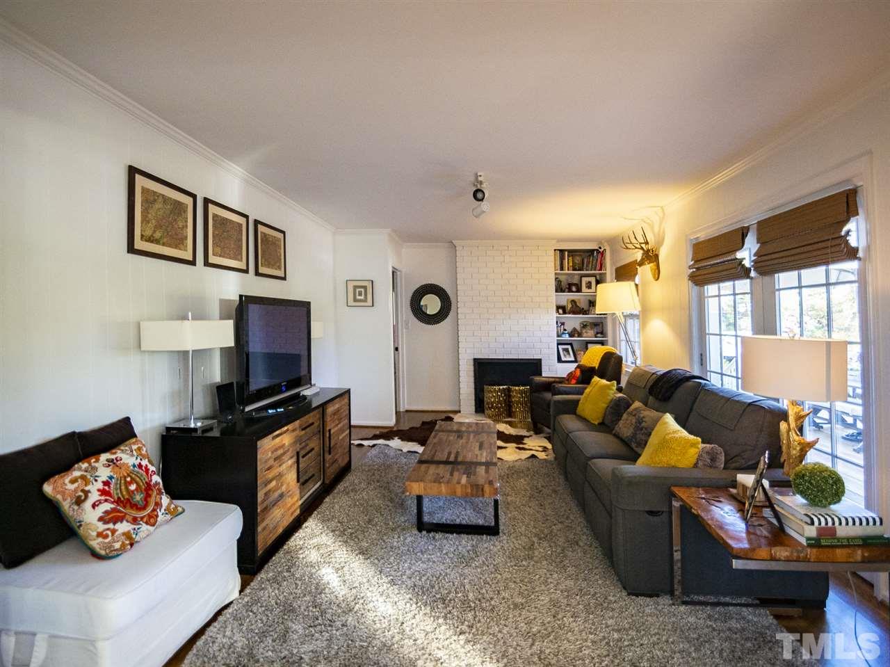 2324 Ridge Road Raleigh, NC 27612 - Photo 15 of 25 a living room with furniture fireplace and a window