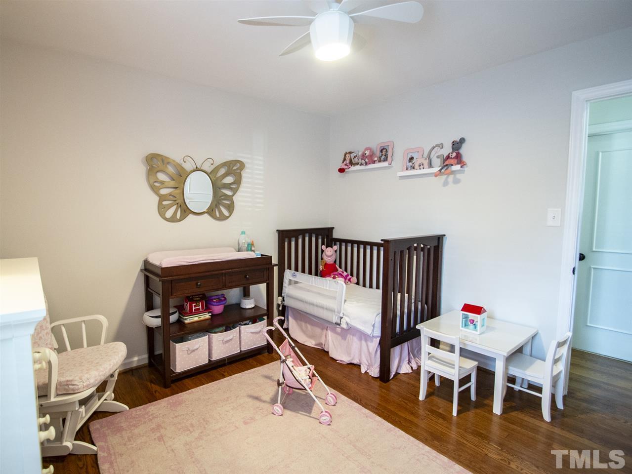2324 Ridge Road Raleigh, NC 27612 - Photo 19 of 25 a bedroom with furniture and a chair