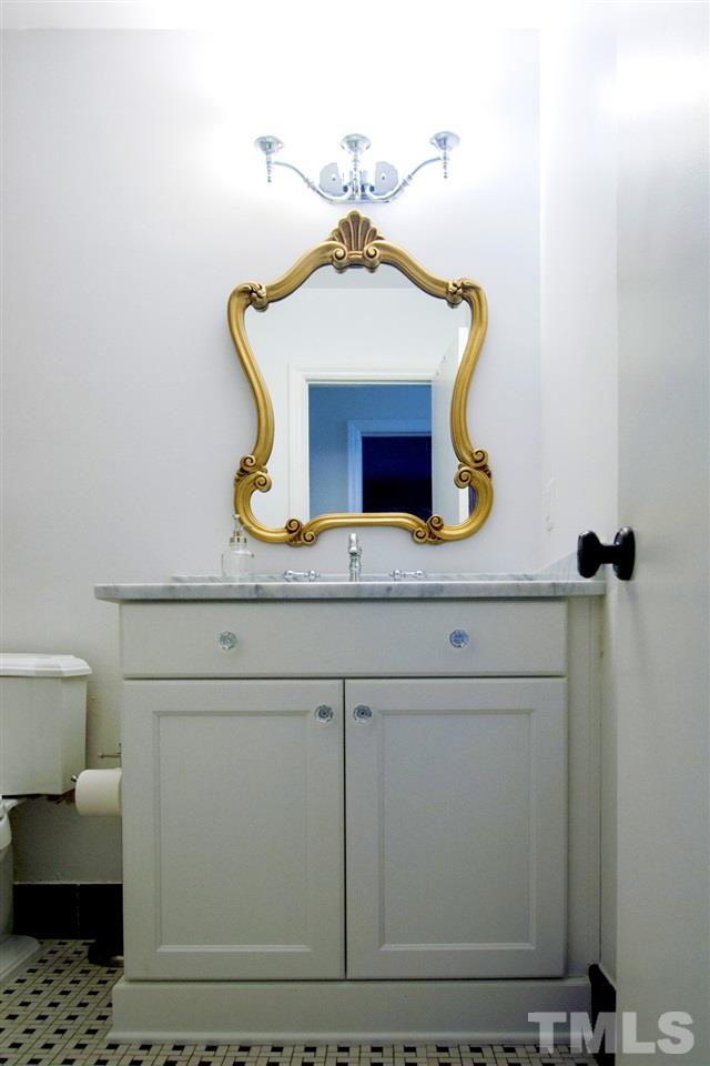 2324 Ridge Road Raleigh, NC 27612 - Photo 21 of 25 a bathroom with a sink and a mirror
