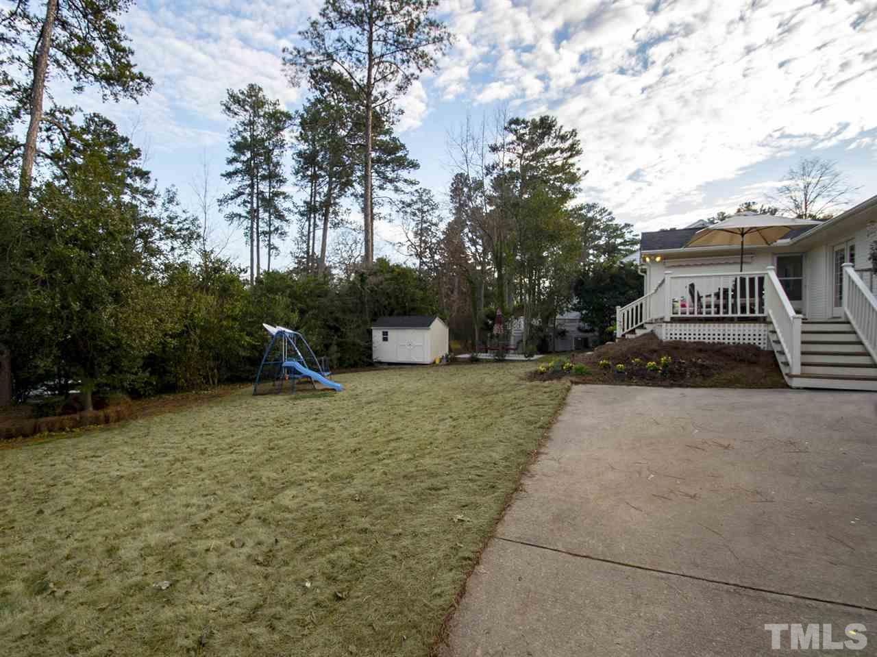 2324 Ridge Road Raleigh, NC 27612 - Photo 24 of 25 a front view of a house with a yard and trees