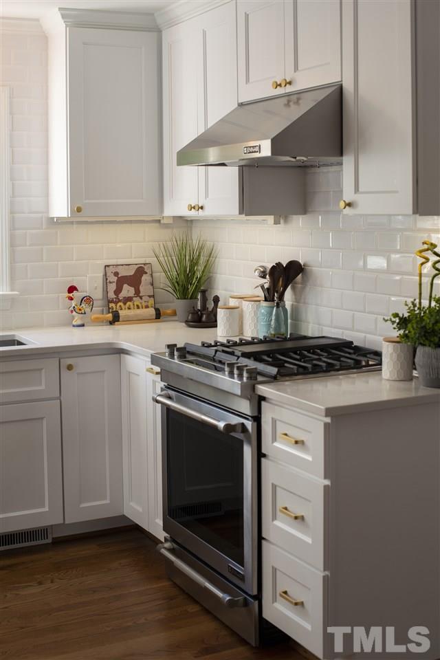 2324 Ridge Road Raleigh, NC 27612 - Photo 10 of 25 a kitchen with cabinets appliances and wooden floor