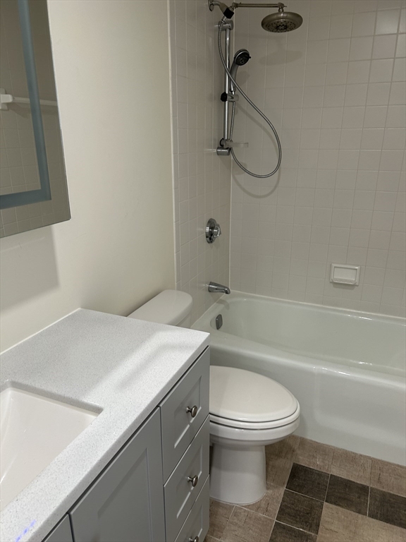 50 Main Street, Unit 409 Watertown, MA 02472 - Photo 8 of 9 a bathroom with a sink a toilet and shower