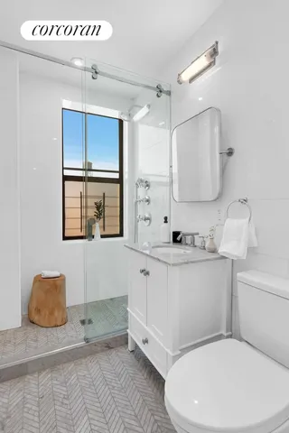 a bathroom with a granite countertop toilet sink and a mirror