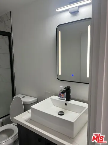 a bathroom with a toilet and a shower