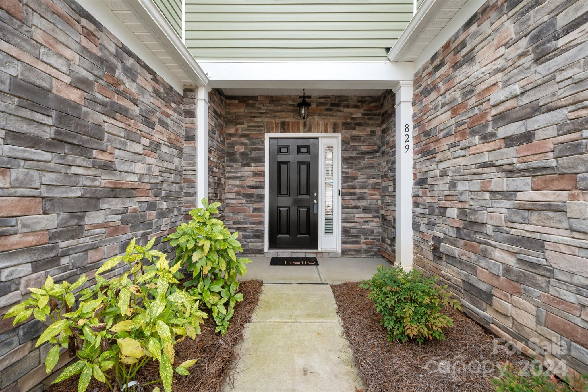 829 Canoe Song Road Fort Mill, SC 29708 - Photo 2 of 38 a front view of a stone house with a large window