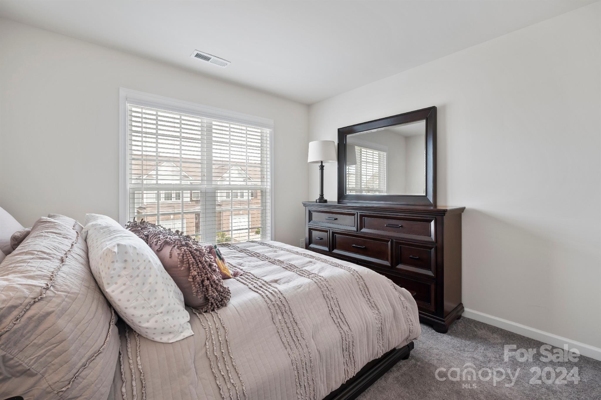 829 Canoe Song Road Fort Mill, SC 29708 - Photo 30 of 38 a bedroom with a bed and a window