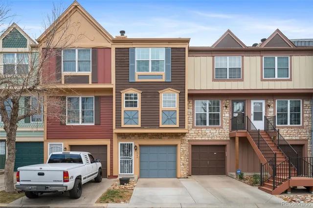 a front view of a residential apartment building with a yard