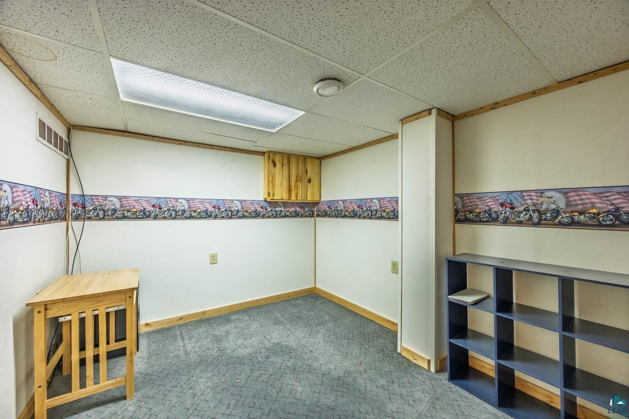319 Michigan Avenue West Gilbert, MN 55741 - Photo 23 of 48 Finished room featuring a drop ceiling, recessed lighting, and patterned carpet flooring