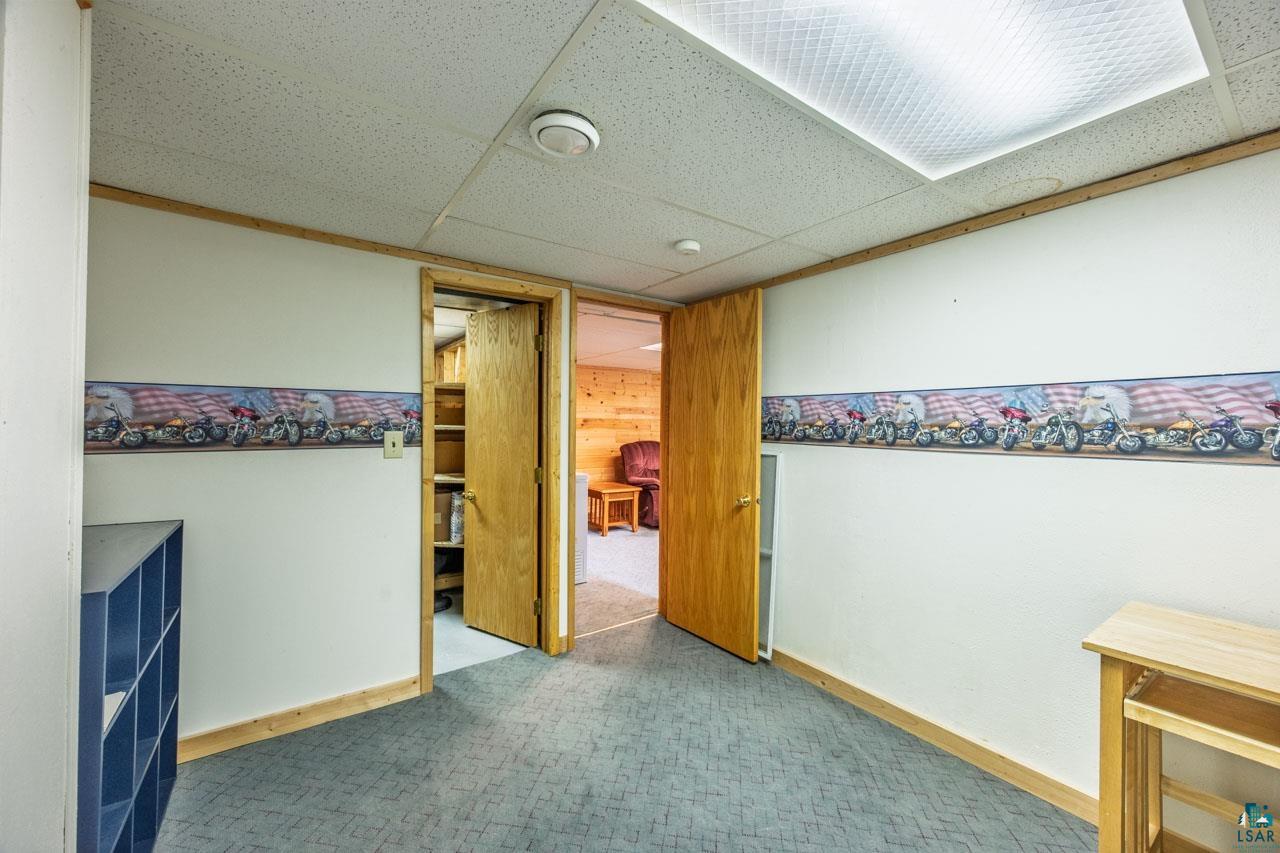319 Michigan Avenue West Gilbert, MN 55741 - Photo 24 of 48 Interior space with textured carpeting, white walls, and wood trim