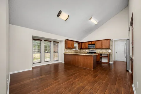a kitchen with stainless steel appliances a sink and a stove top oven