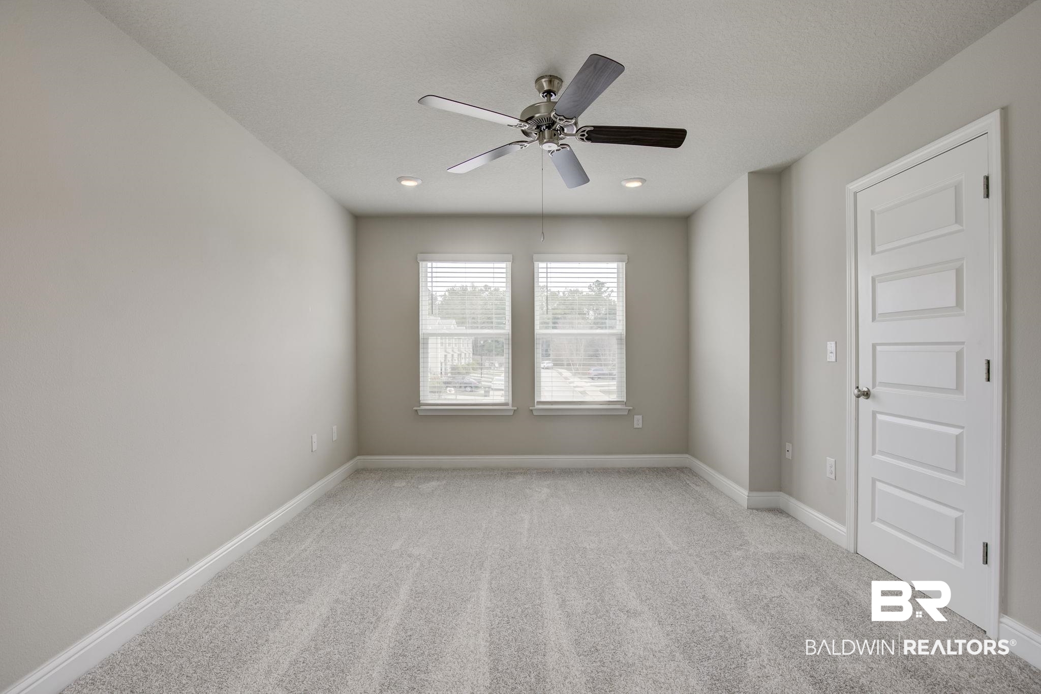25806 Pollard Road, Unit 60 Daphne, AL 36526 - Photo 20 of 35 Spare room with a textured ceiling, light colored carpet, and ceiling fan