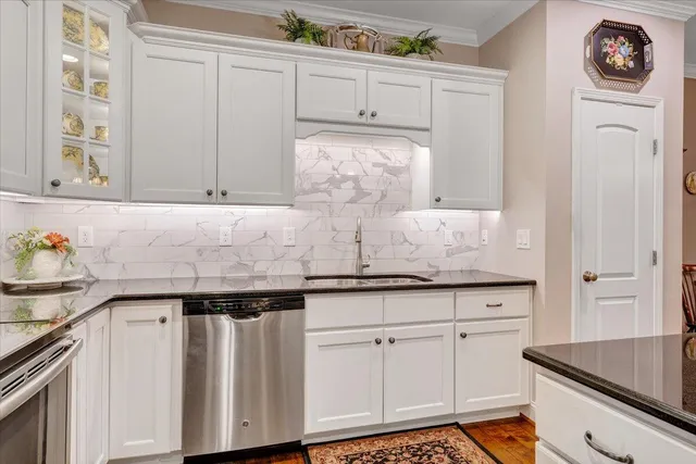 a living room with furniture a dining table and a chandelier