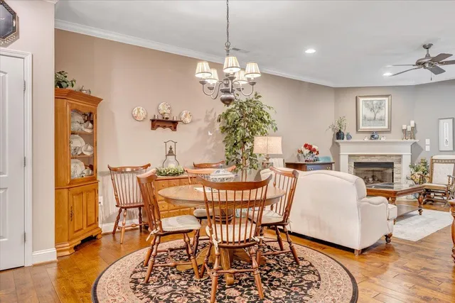 a living room with furniture a chandelier and a fireplace