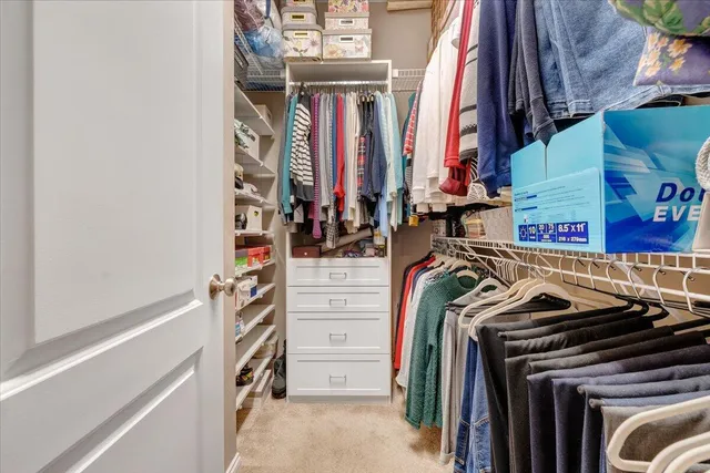 a living room with furniture and a dining table with bookshelf