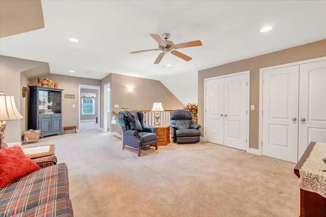 a view of a patio with table and chairs potted plants and floor to ceiling window