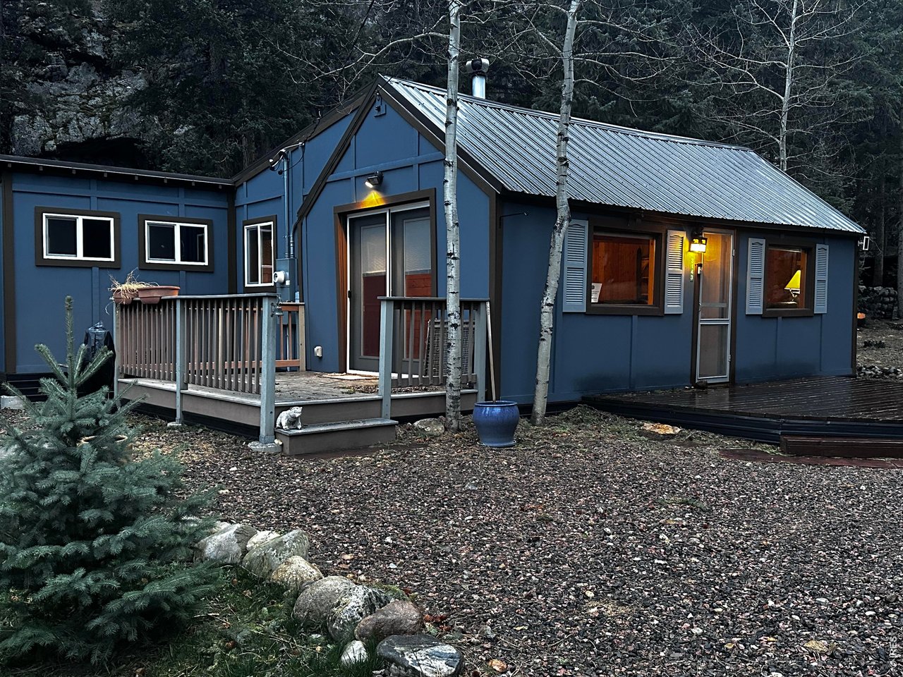 a view of a house with a small yard and wooden fence