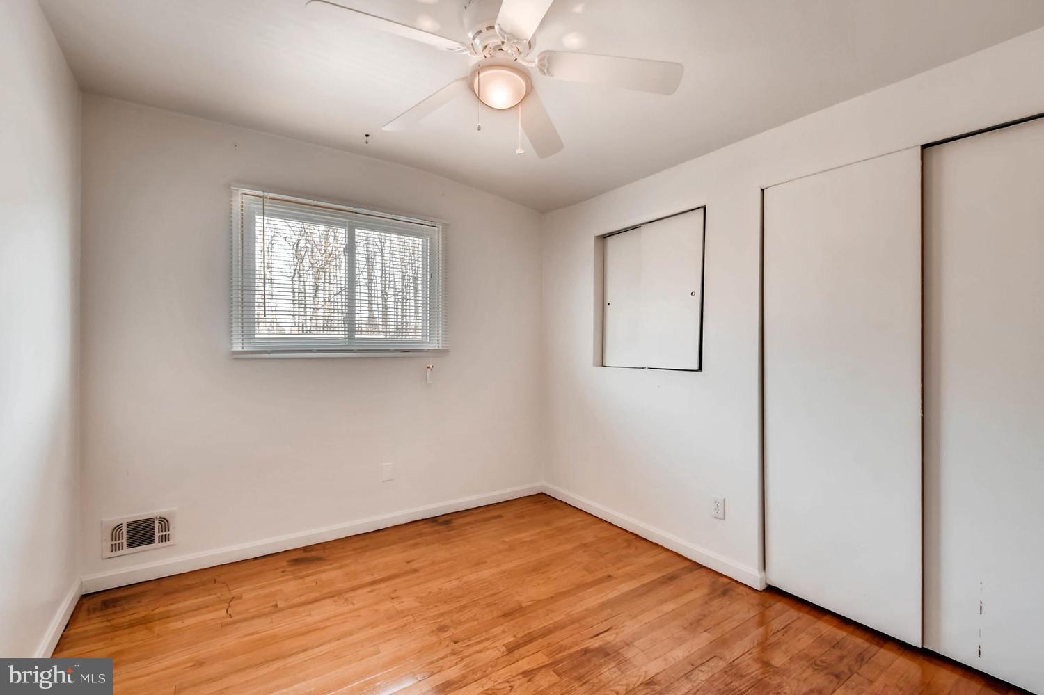 3306 Southgreen Road Baltimore, MD 21244 - Photo 8 of 14 wooden floor in an empty room with a window