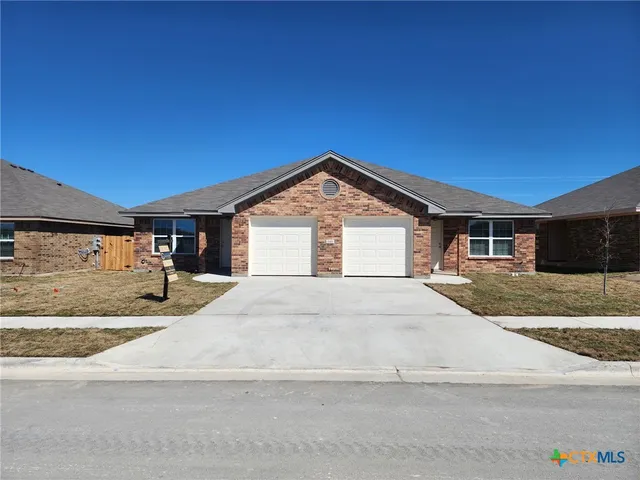 a view of an house with backyard space and kitchen