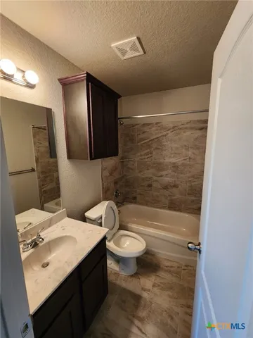 a bathroom with a sink a toilet a mirror and shower
