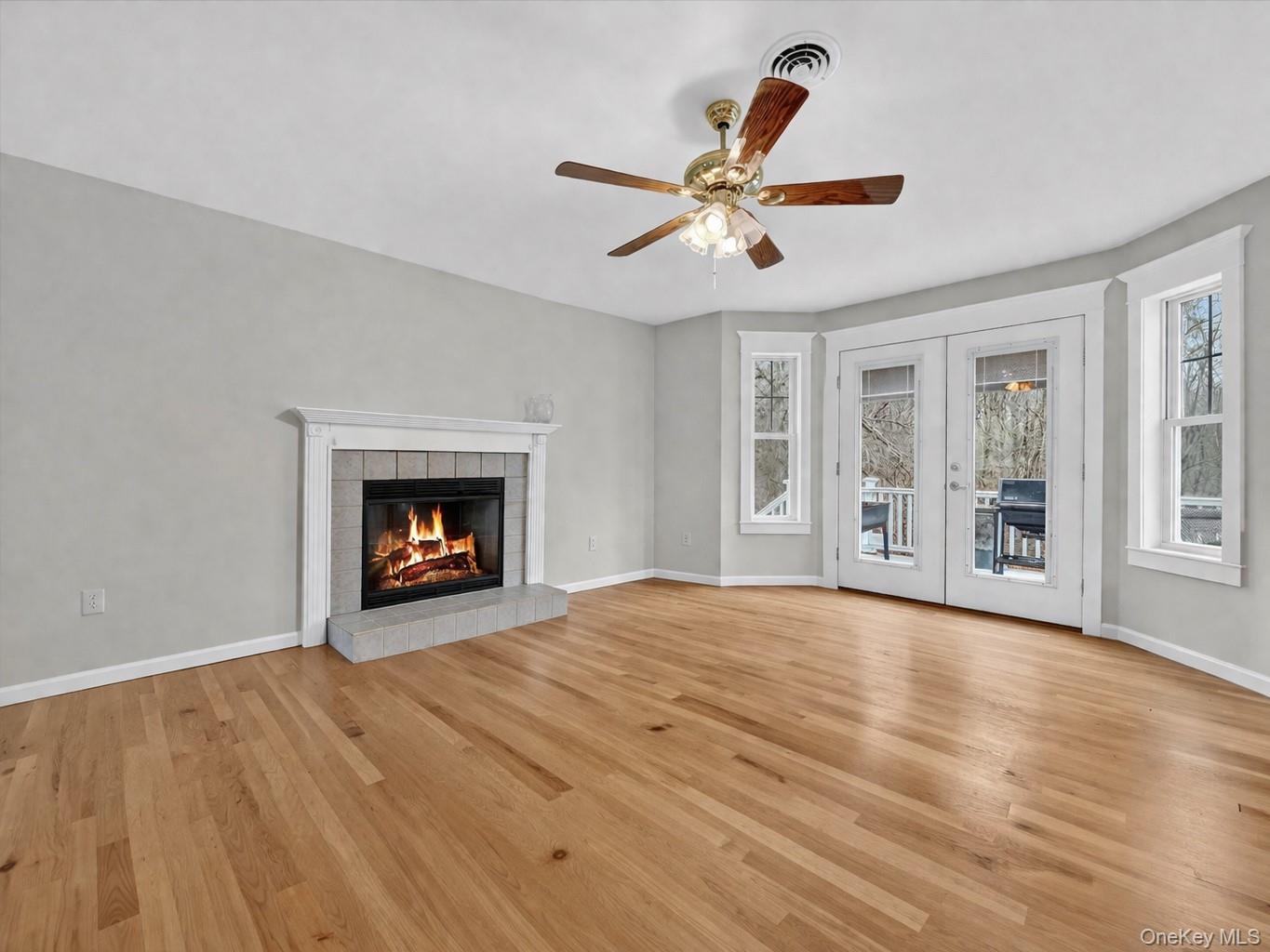 89 James Wilkinson Road Rock Tavern, NY 12575 - Photo 10 of 11 a view of an empty room with wooden floor fireplace and a window