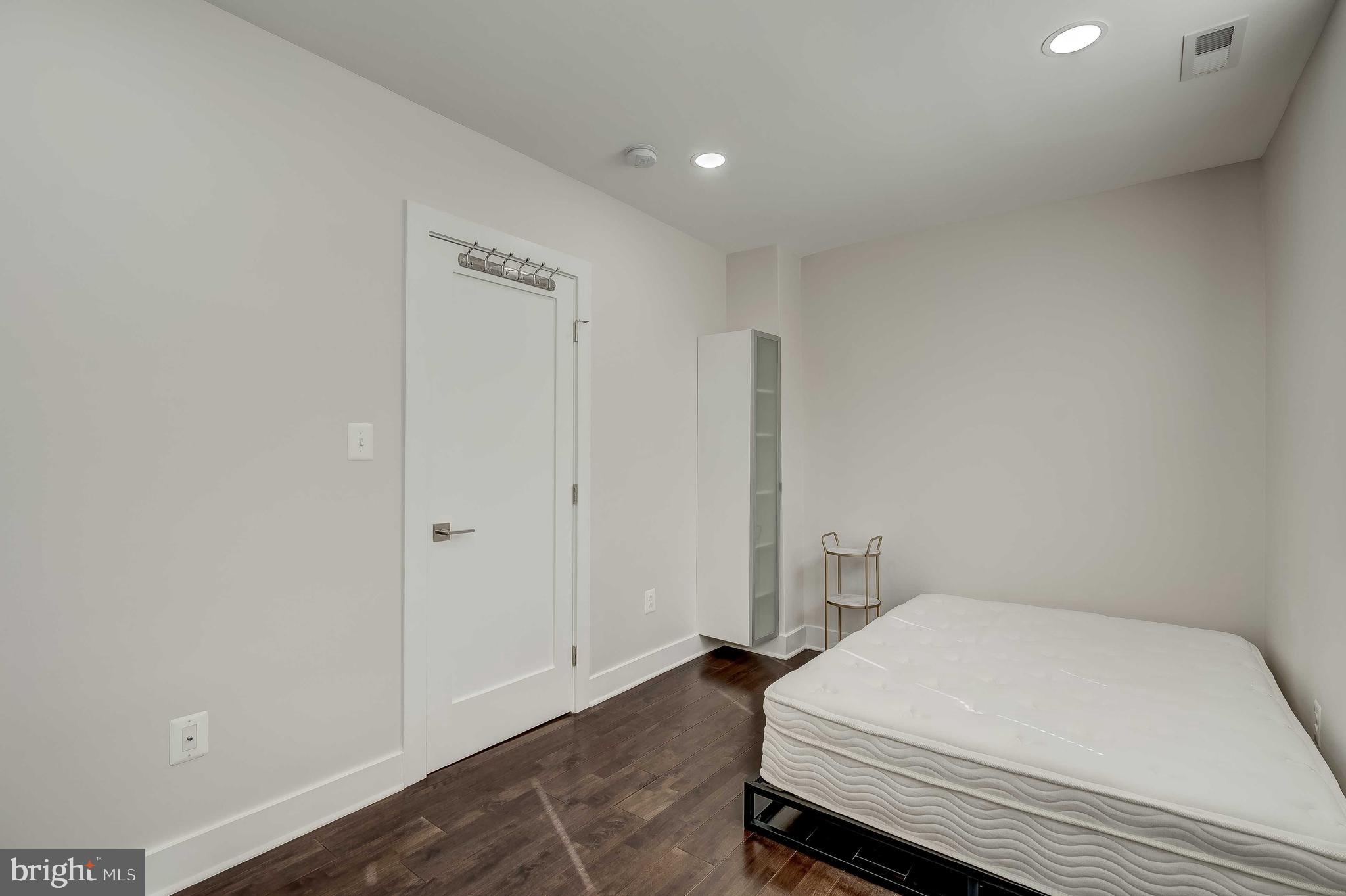 1605 F Street Northeast, Unit 2 Washington, DC 20002 - Photo 13 of 29 a room with a bed and cabinets