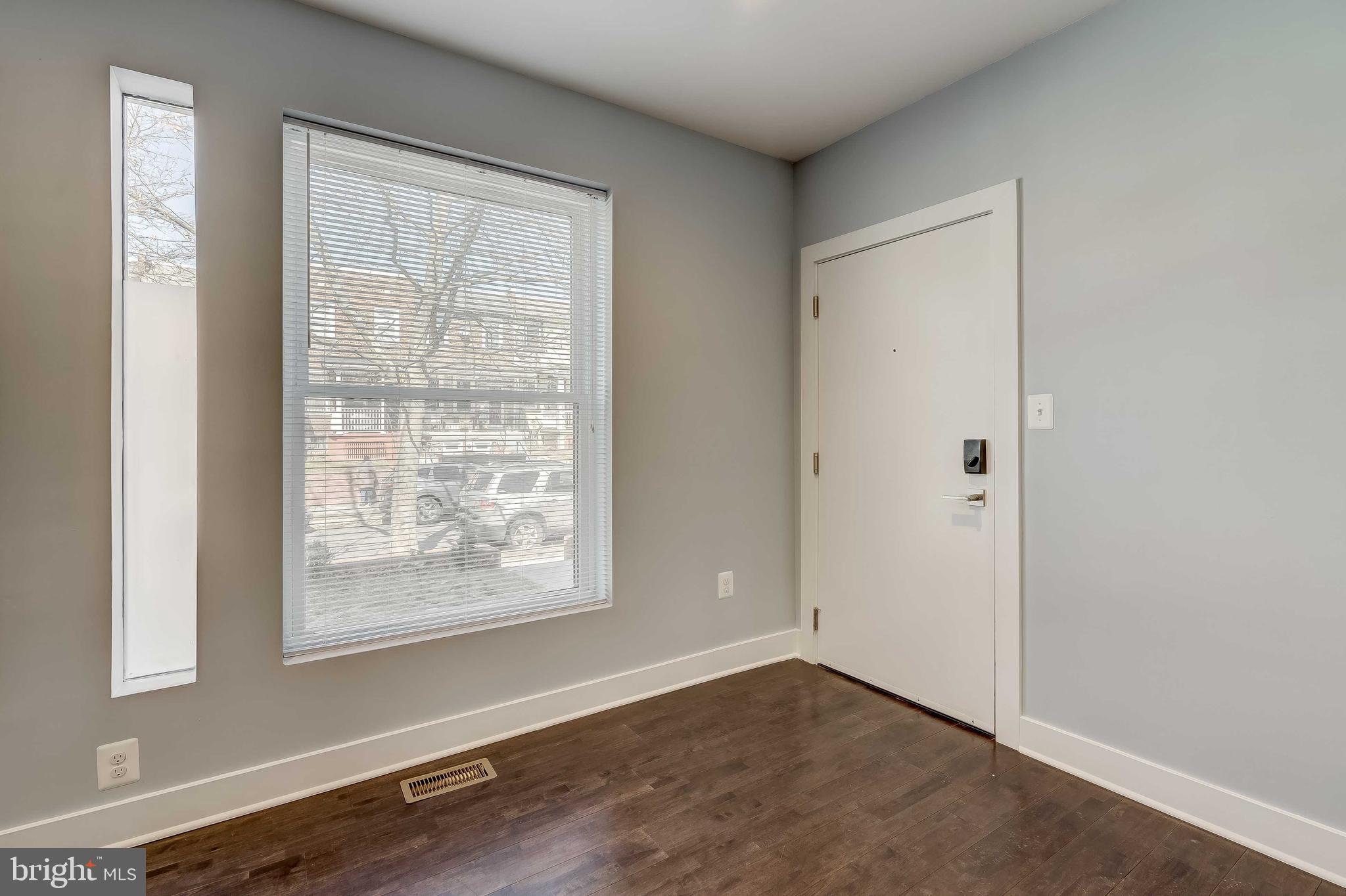 1605 F Street Northeast, Unit 2 Washington, DC 20002 - Photo 2 of 29 an empty room with wooden floor and windows