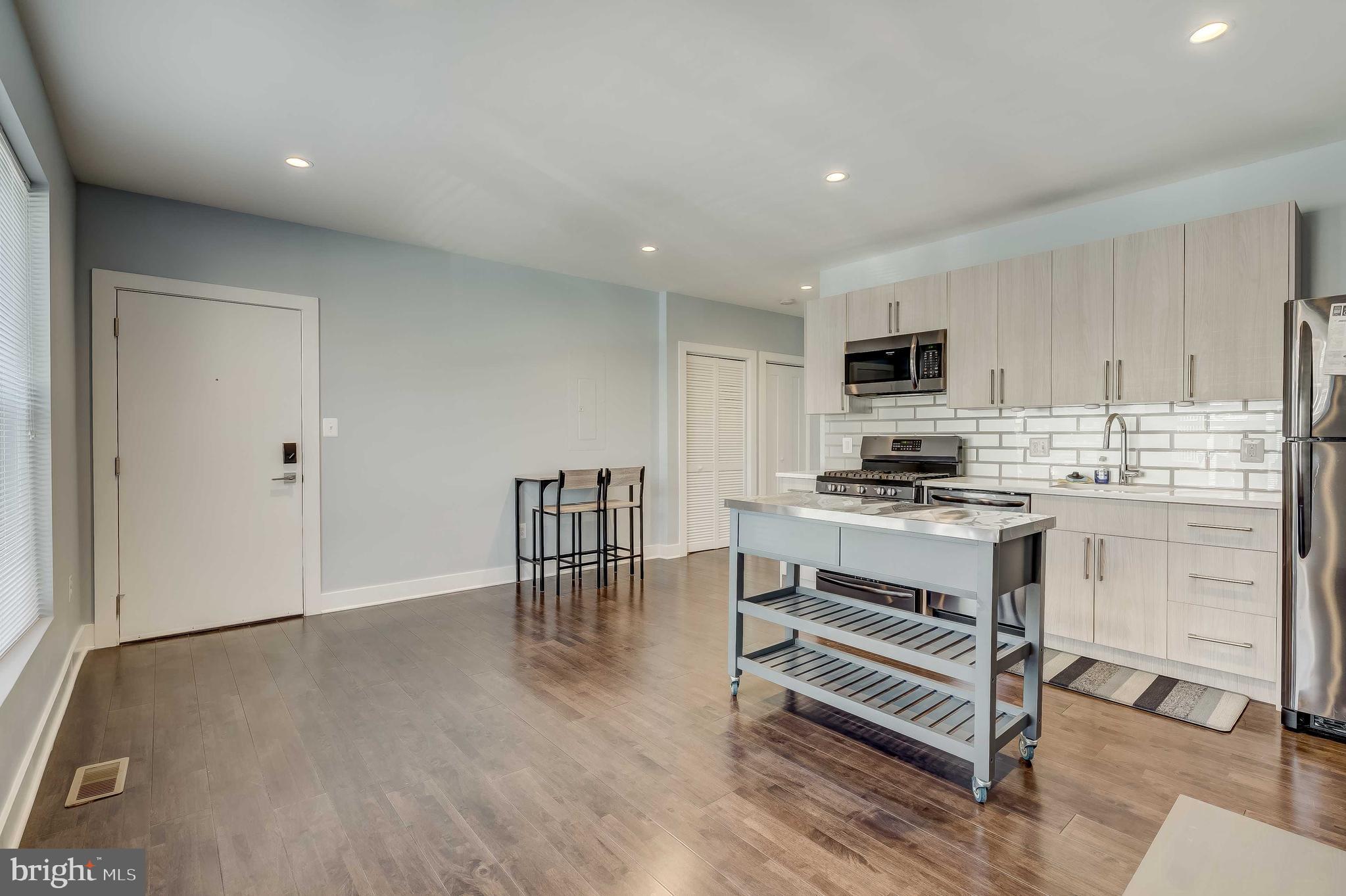 1605 F Street Northeast, Unit 2 Washington, DC 20002 - Photo 5 of 29 a kitchen with a refrigerator and white cabinets