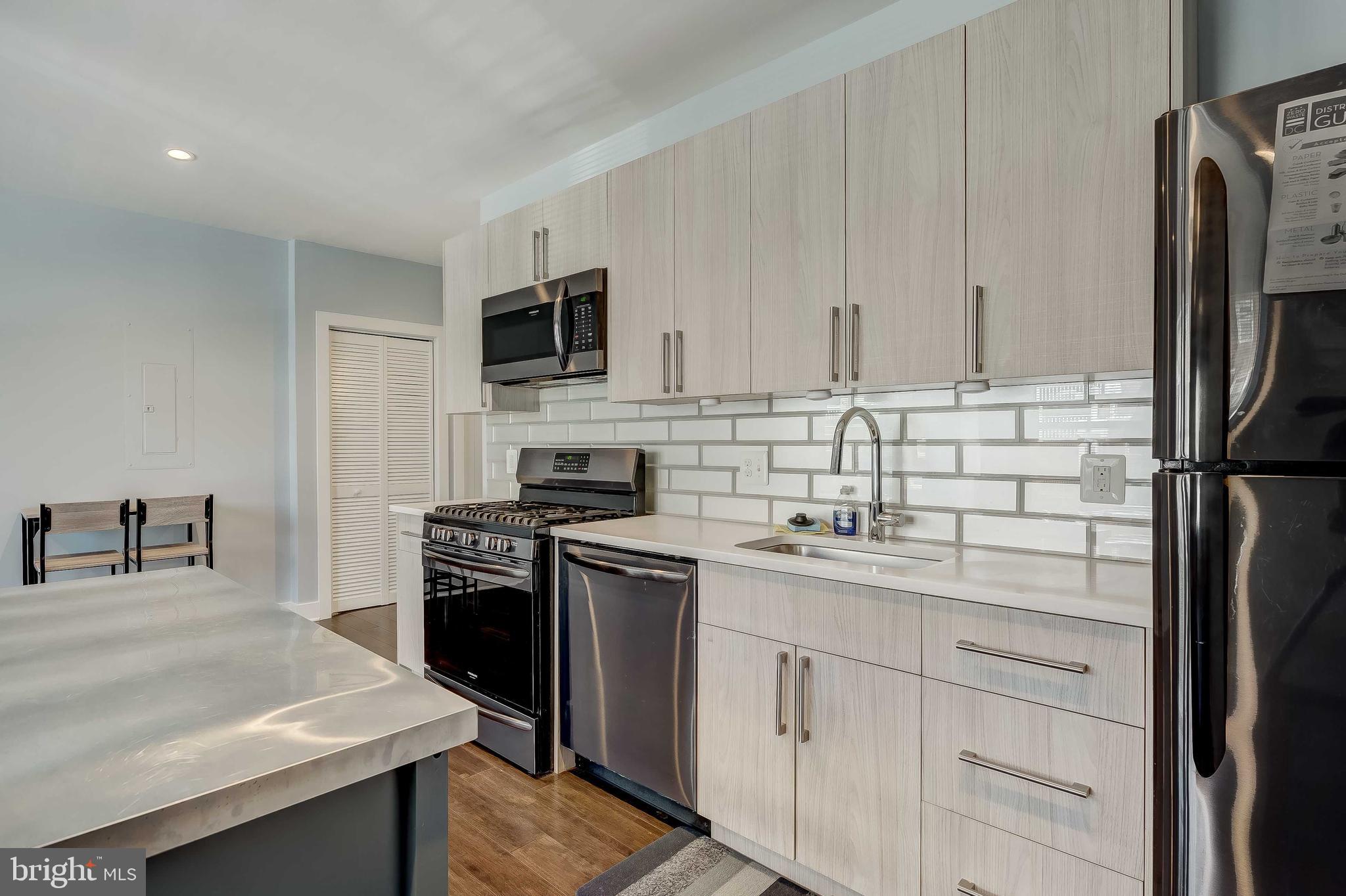 1605 F Street Northeast, Unit 2 Washington, DC 20002 - Photo 7 of 29 a kitchen with appliances a sink and cabinets