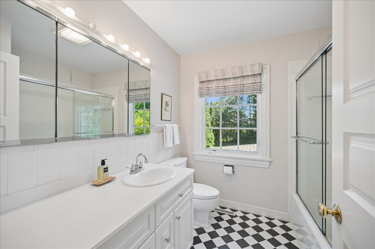 253 Summerfield Road Northbrook, IL 60062 - Photo 32 of 46 a bathroom with a sink a toilet and a window