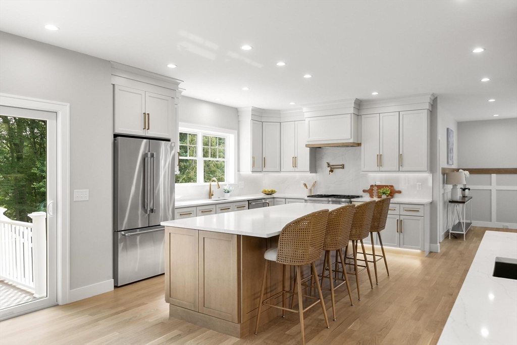 29 Beaverbrook Road Burlington, MA 01803 - Photo 11 of 42 a kitchen with stainless steel appliances granite countertop a refrigerator a sink a stove a dining table and chairs