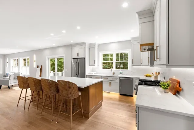 a kitchen with a stove a sink a dining table and chairs